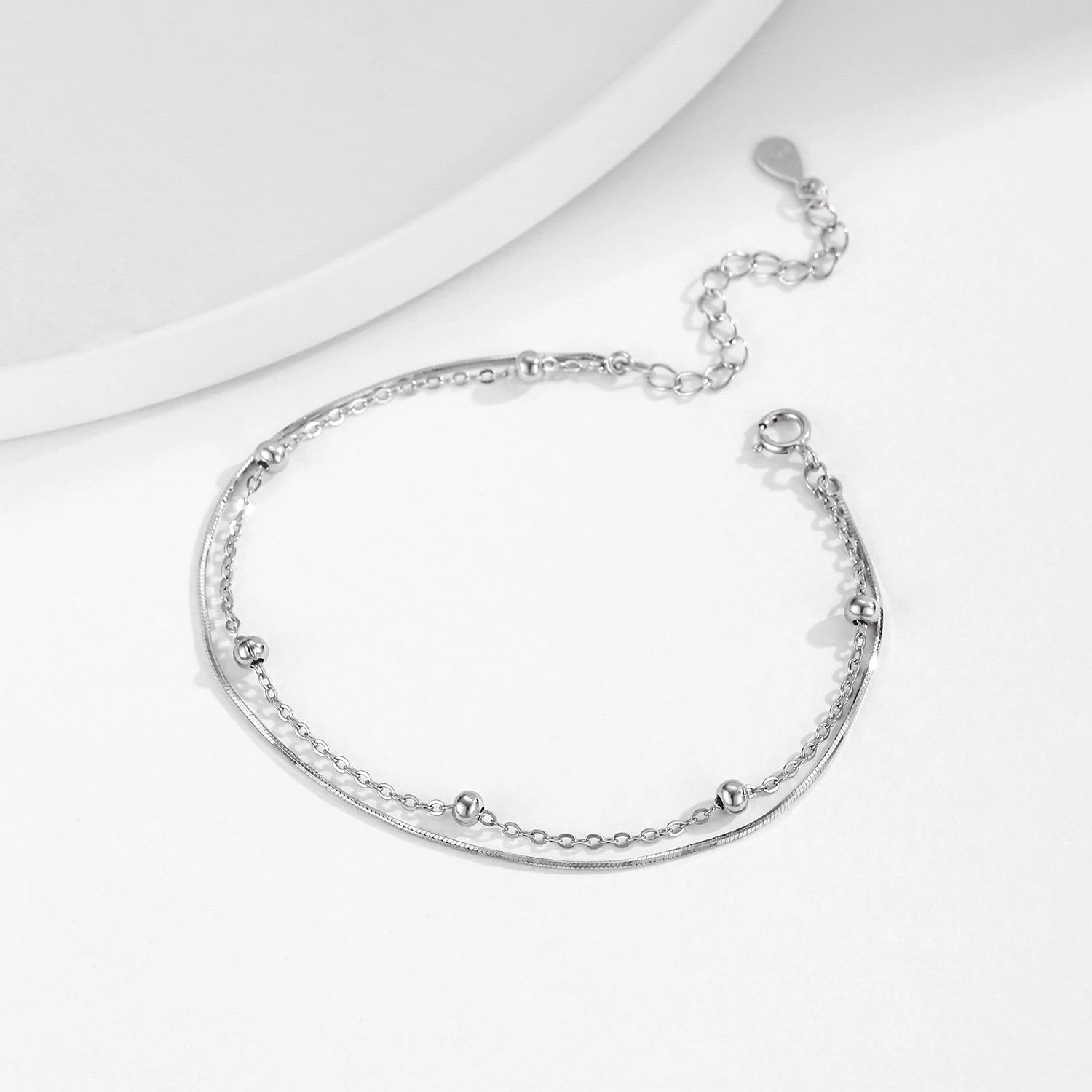 Close view of 925 silver snake bracelet paired with a silver bangle