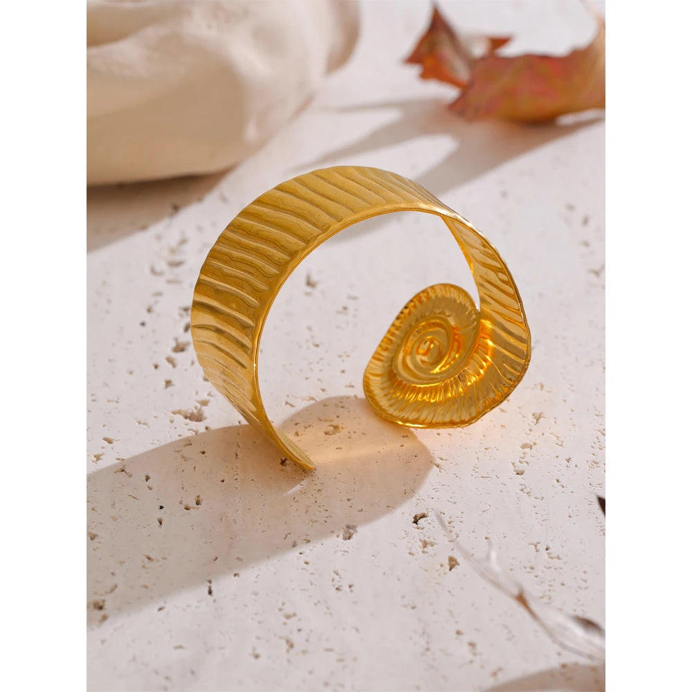 Elegant flat lay pairing bracelet with gold accents and a sculptural cuff