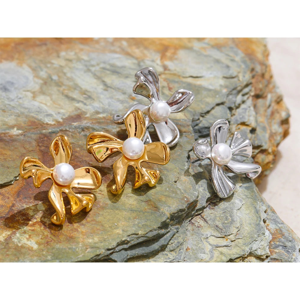 Close view of flower earrings accentuated by earrings gold earrings tones