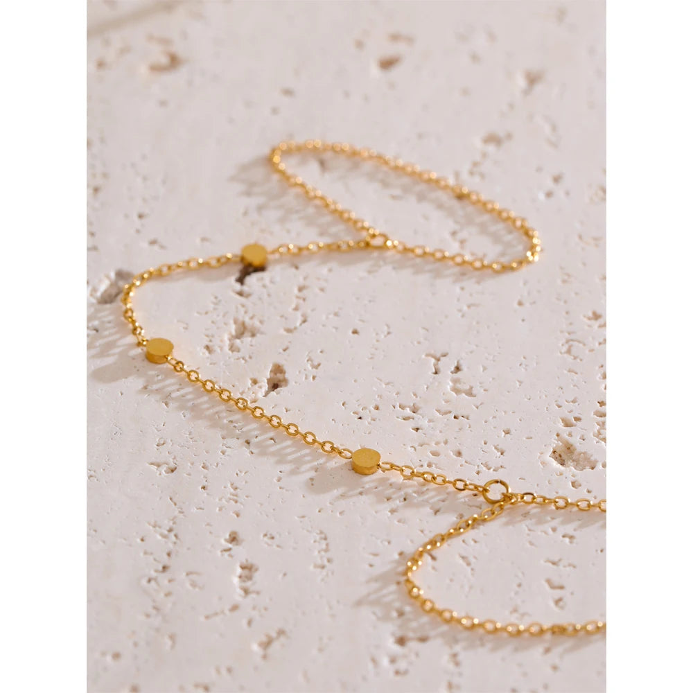 Flat lay of bracelet chain and hand chain styled as waterproof jewelry accent