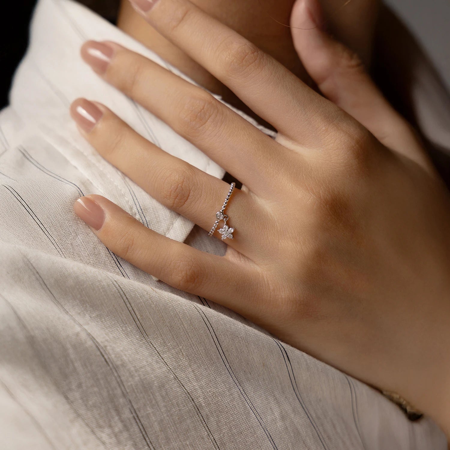 Flower moissanite ring featuring bead and star details in silver