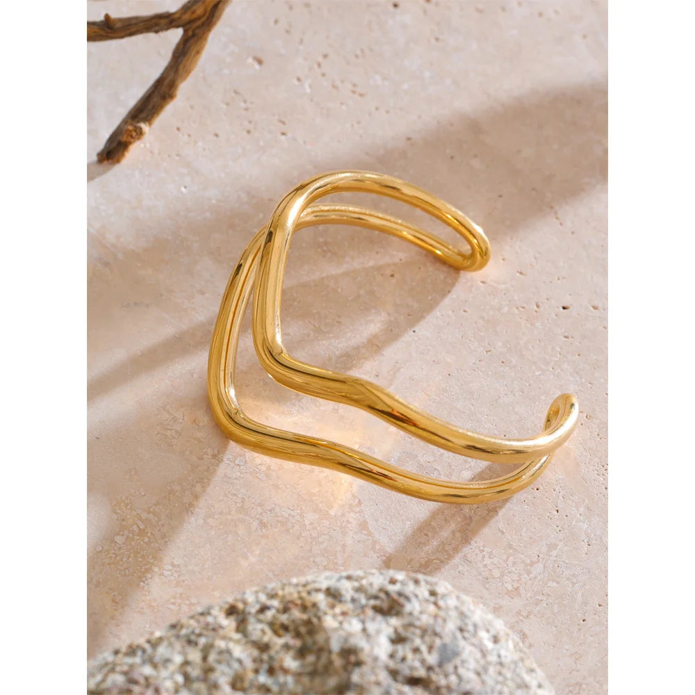 Gold plated bangle bracelet paired with bangle and bangle stack