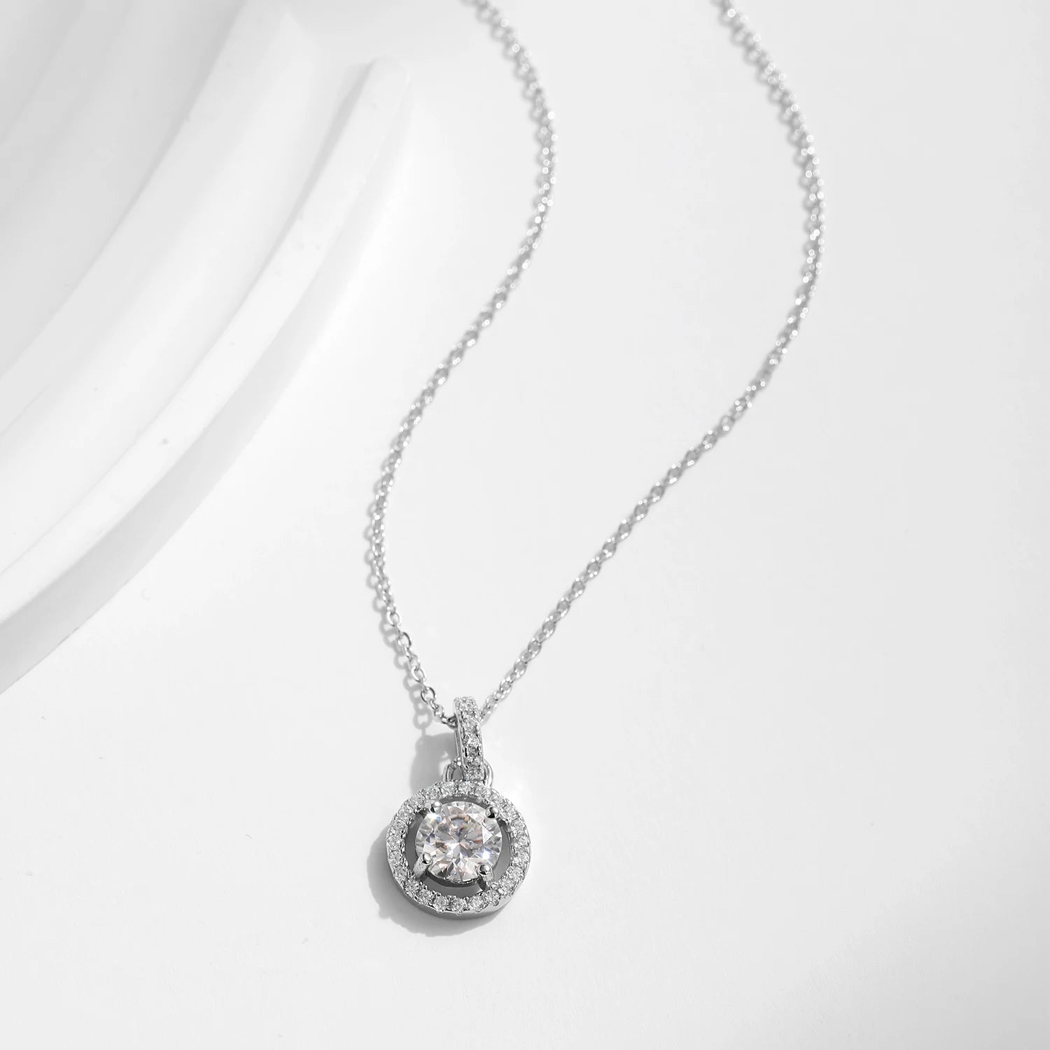 Minimalist charm necklace style featuring a bright moissanite pendant