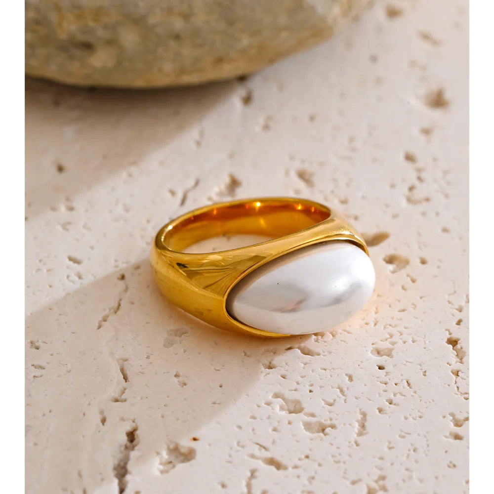 Close up of chic golden rings with simulated pearls design
