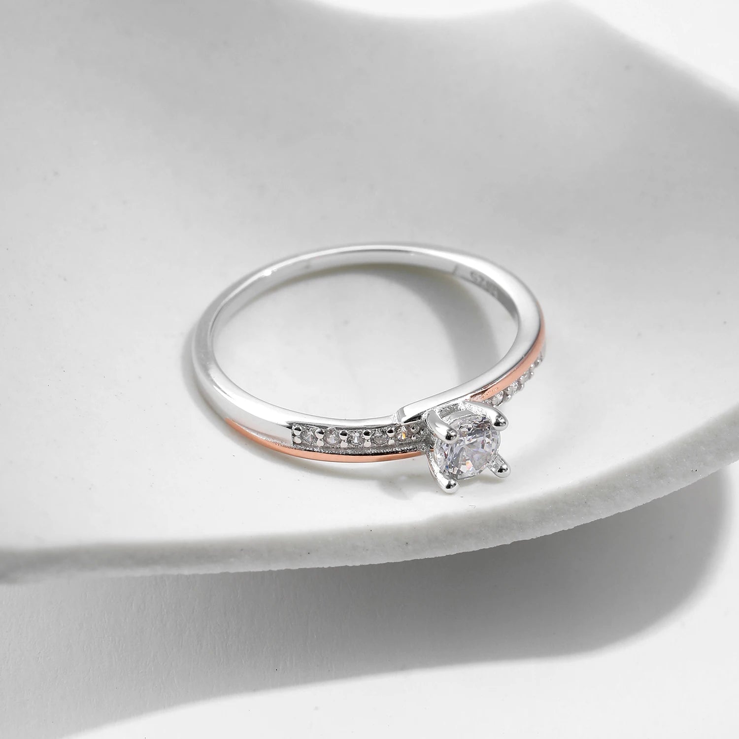 Elegant wedding ring ring featuring a silver ring body and delicate rose gold line
