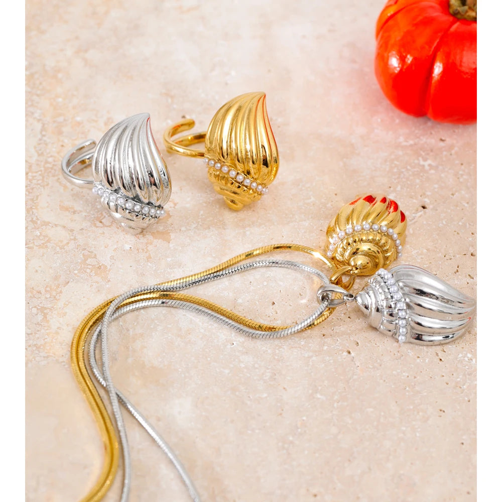 Studio shot showing pendant in necklace texture beside a ring with pearls accent