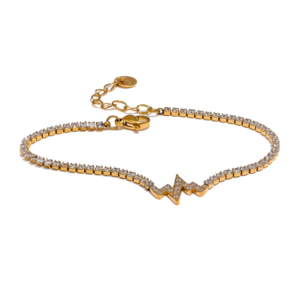 Cubic zirconia charm bracelet on a gold chain bracelet with subtle shine