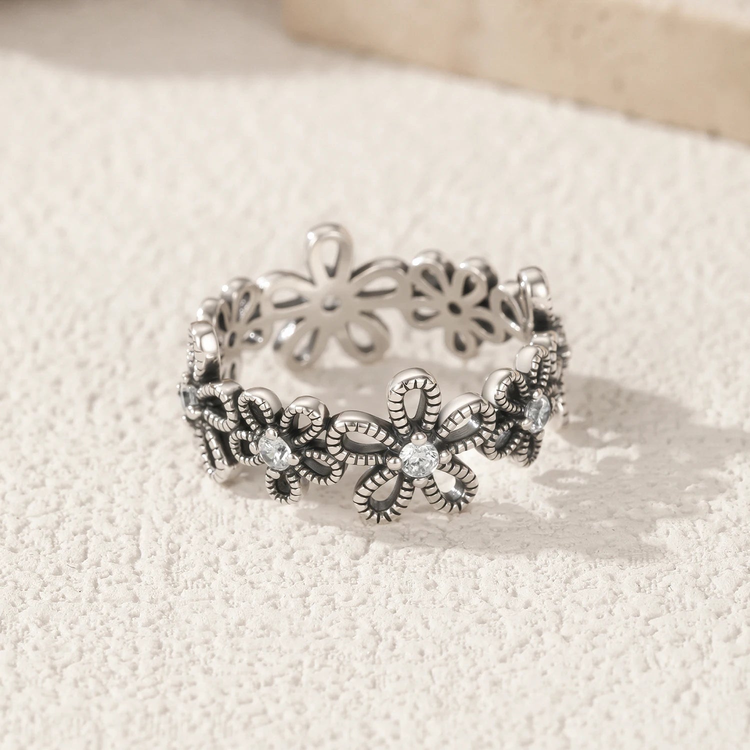 Openwork hollow flower eternity ring in sterling silver