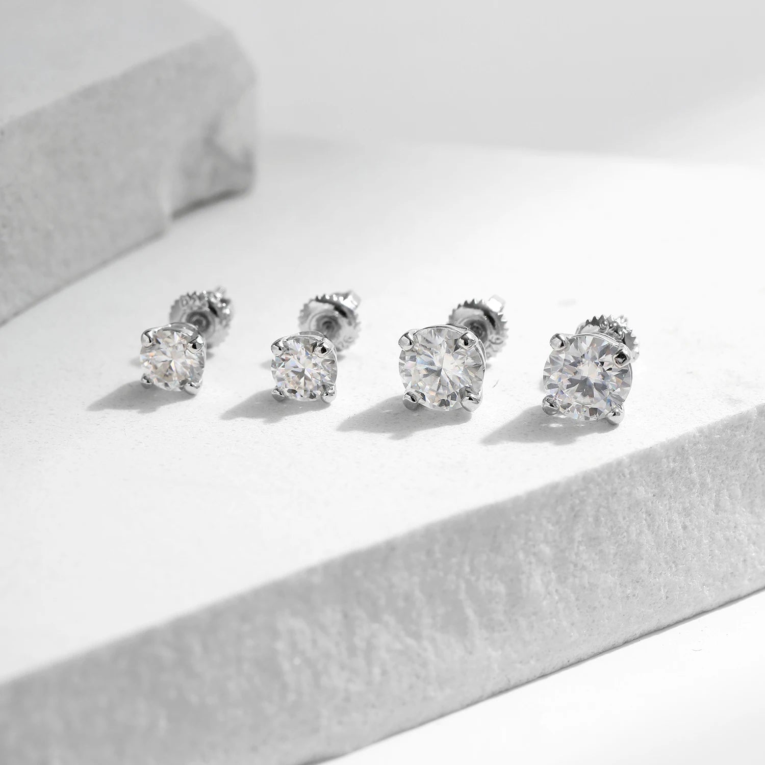 Polished 925 sterling silver studs displaying moissanite jewelry sparkle