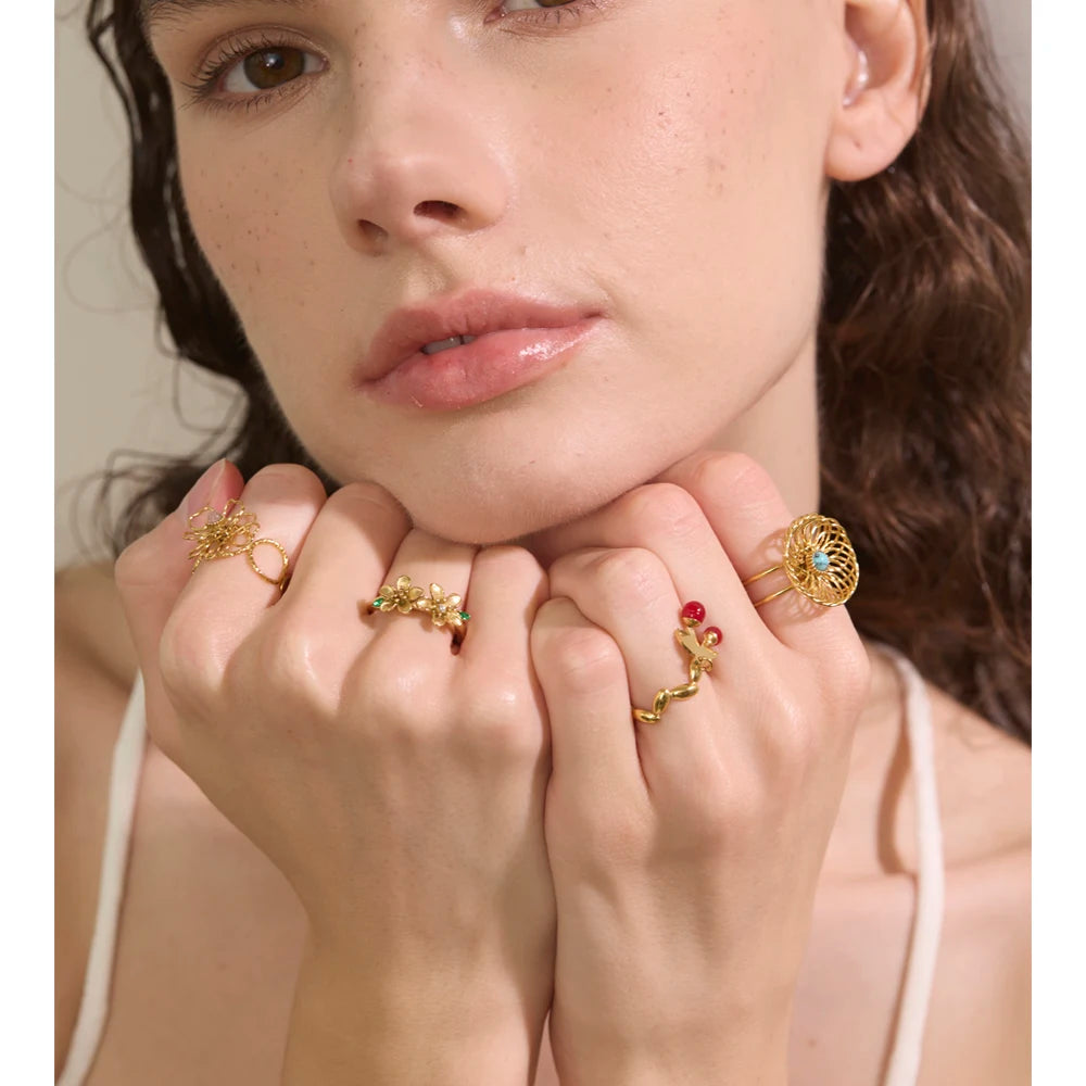 Gold ring featuring a natural stone flower motif and adjustable open band for finger and ring styling