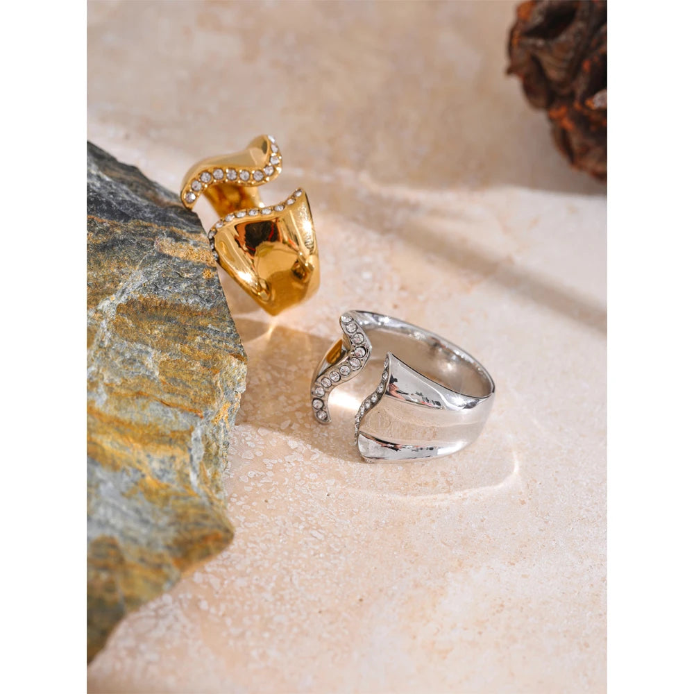Ring with gold wave shape and cubic zirconia accents