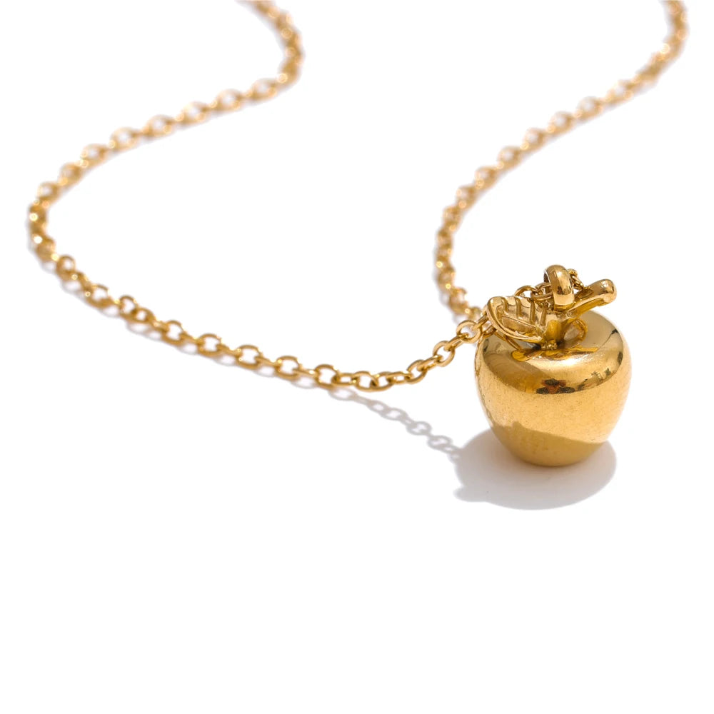 Apple pendant on a gold necklace with subtle gold in necklace shine