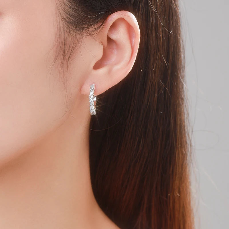 Close view of sterling silver hoop earrings with rhombus zircon shine