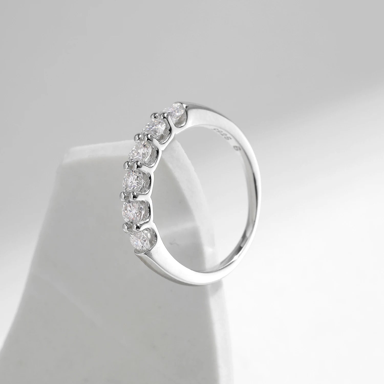 Minimal shot showing ring size options beside the ring moissanite band