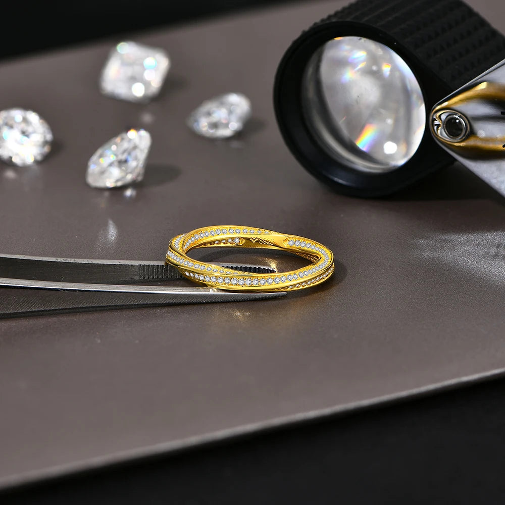 Rings with moissanite paired beside a classic gold ring in a tray