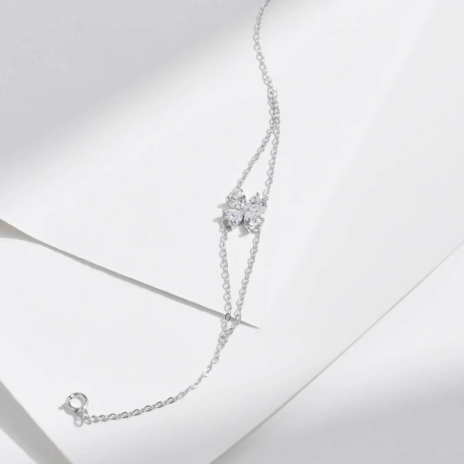 Sterling silver chain supporting a delicate flower bracelet design
