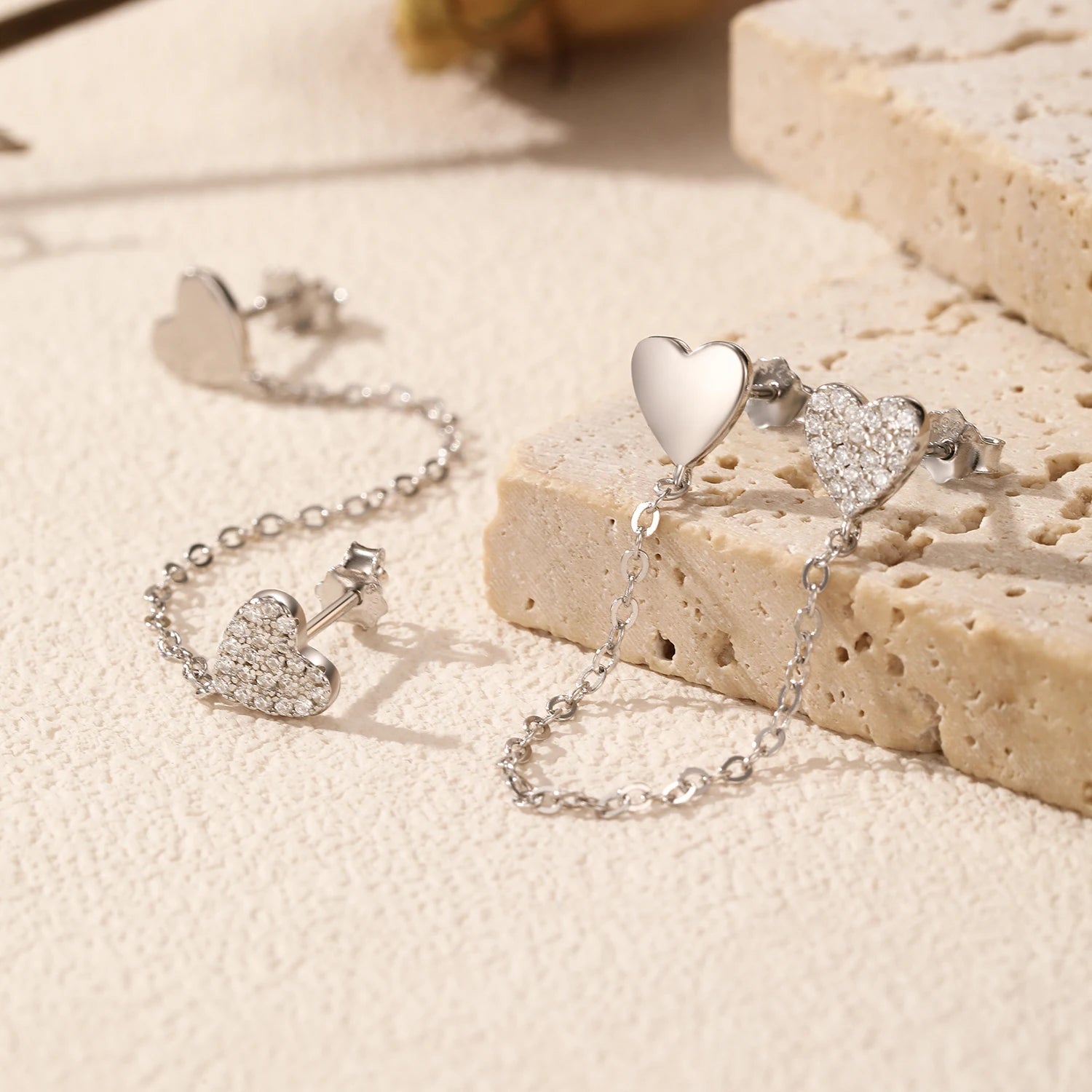 Sterling silver chain tassel earrings featuring mirrored hearts in silver color