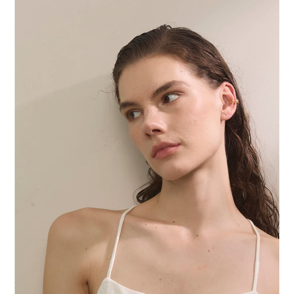 Close up of clip on earrings clip featuring golden heart detail