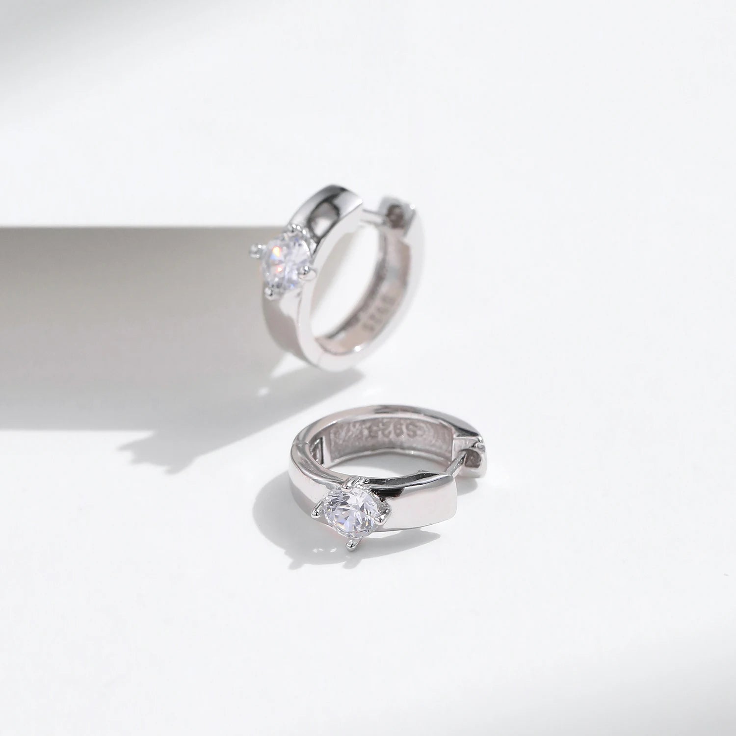 Sterling silver earrings featuring a polished silver hoop