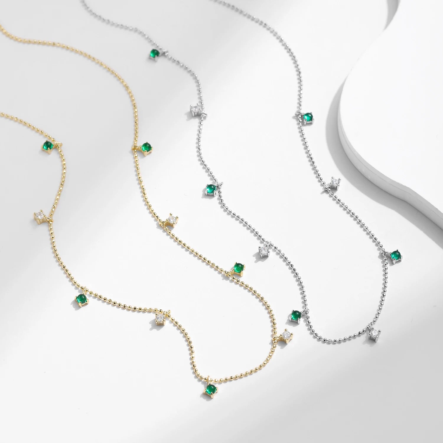 Silver chain supporting a minimal sterling silver necklace pendant