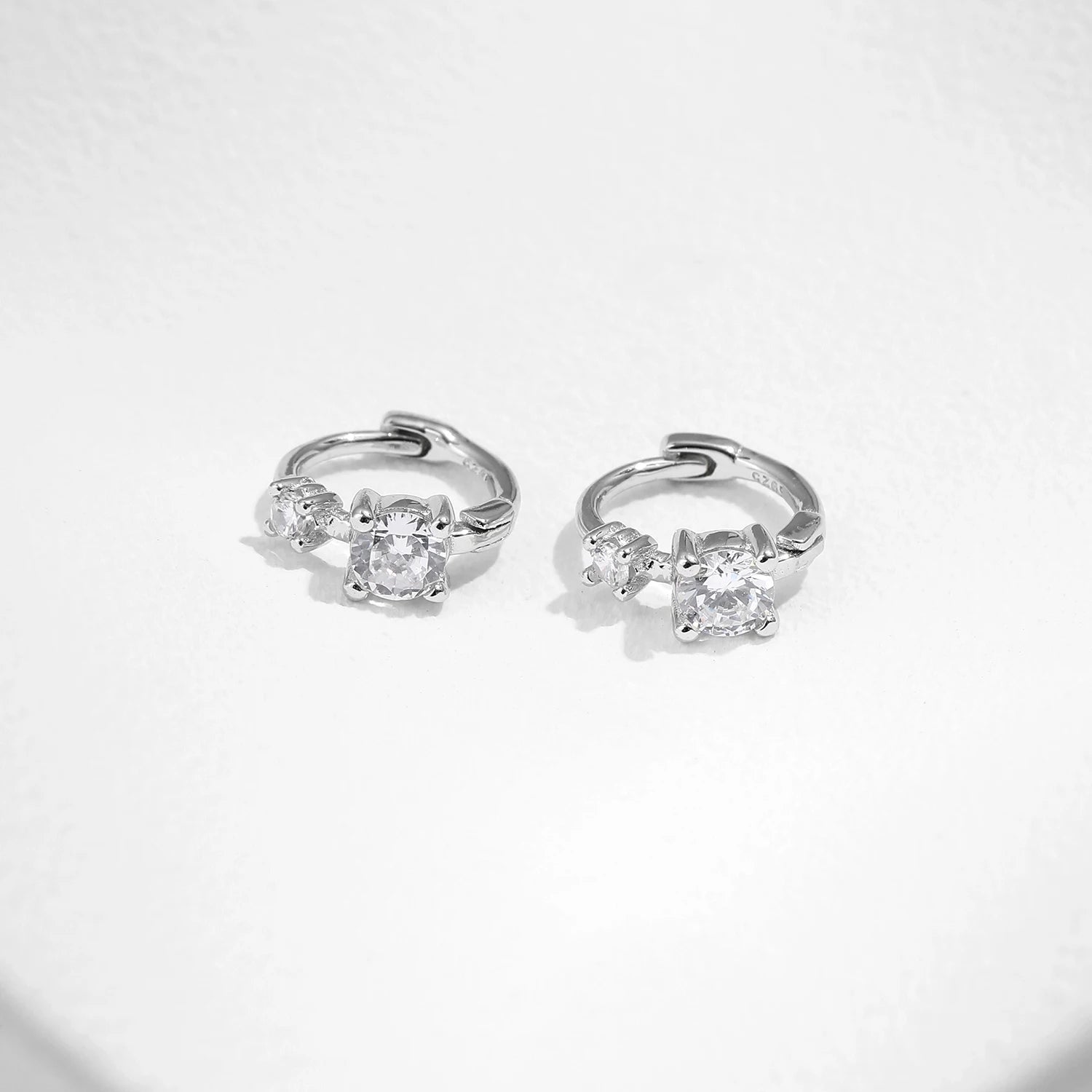 Sterling silver earrings with a polished silver hoop profile