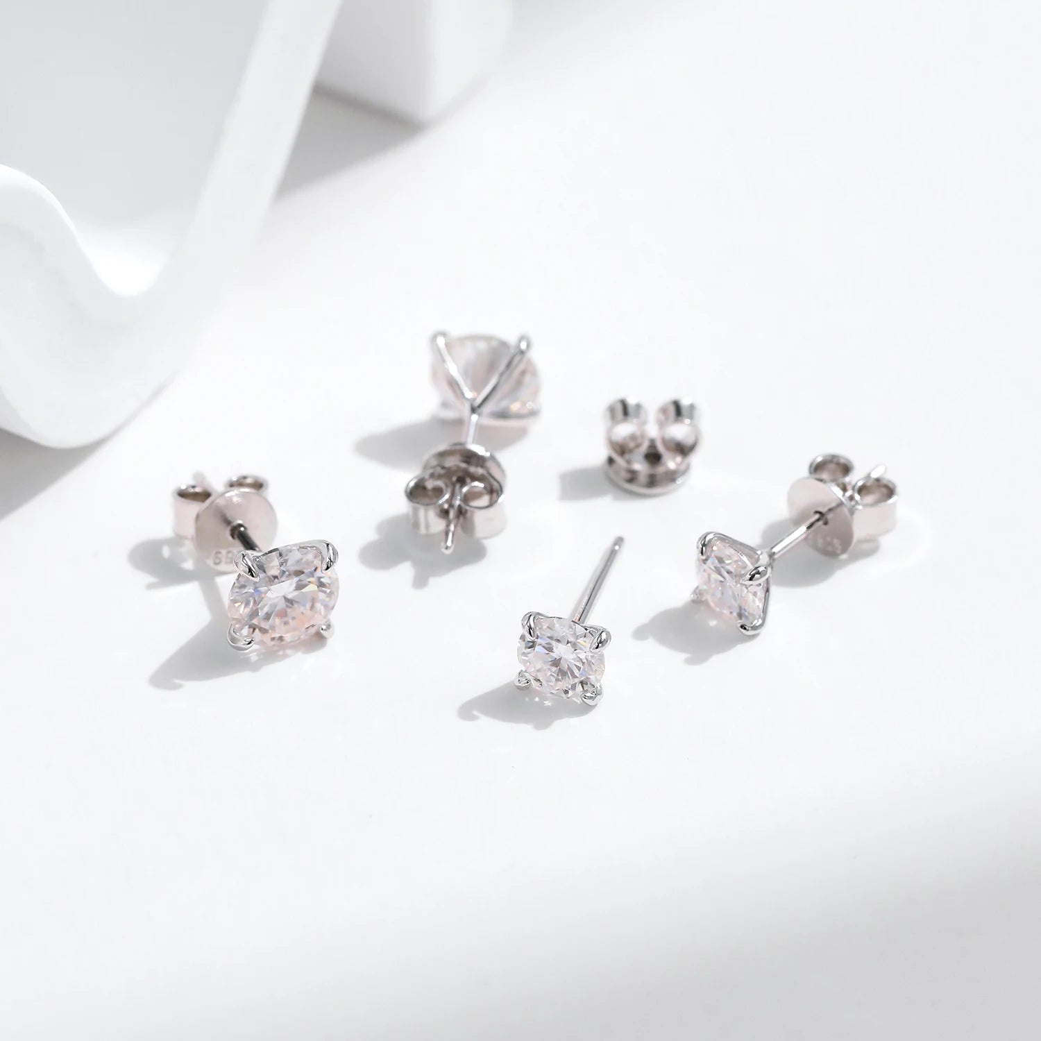Macro facets of moissanite earrings on polished 925 silver posts