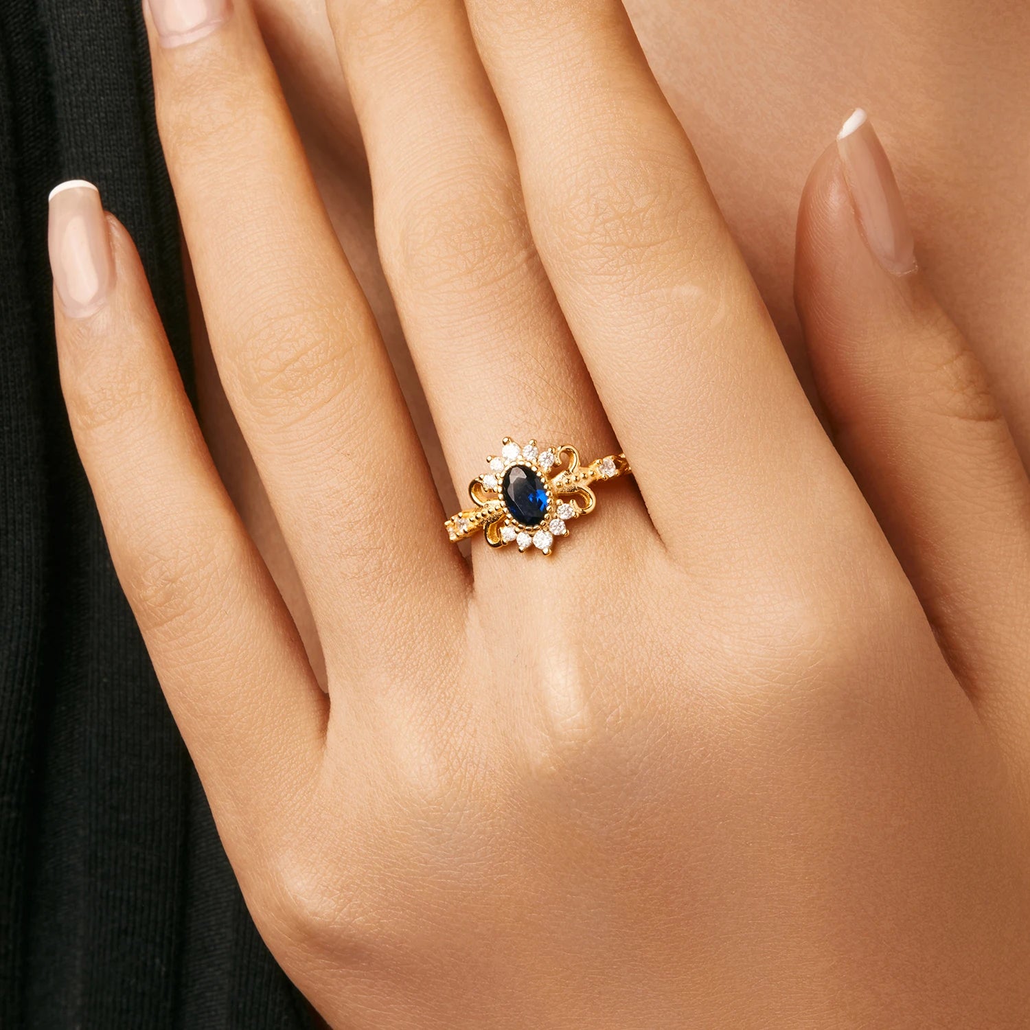 Sterling silver ring with crown motif and blue oval stone