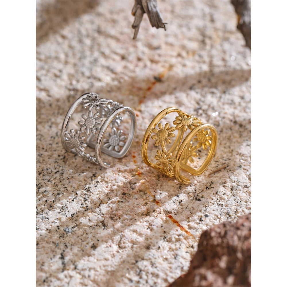 Minimal ring worn on finger displaying adjustable open design and floral motif