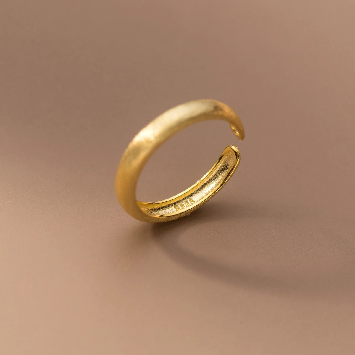 Minimal open silver ring styled as a ring with gold detail