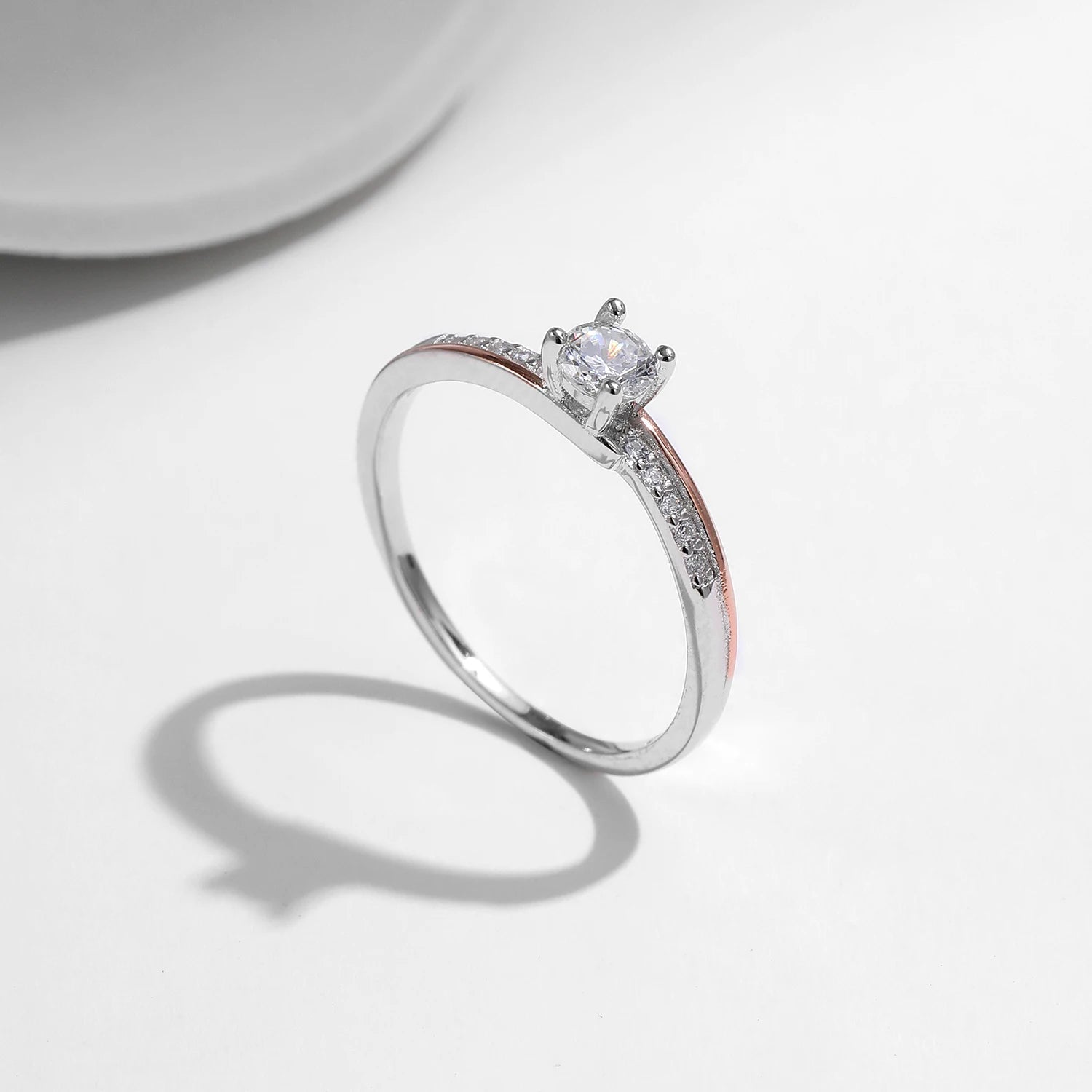 Silver color wedding band photographed with rose gold detail for couples