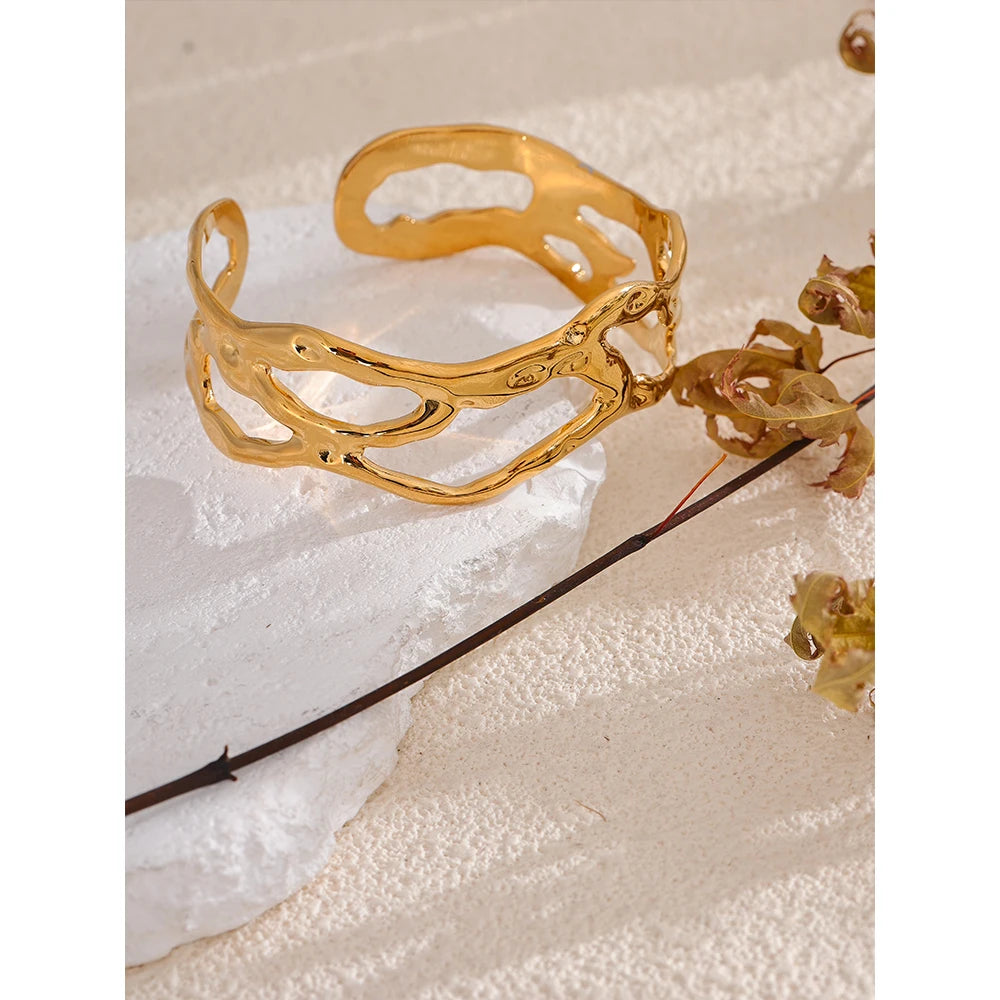 Close view of gold plated gold cuff bracelet beside bracelets bracelet