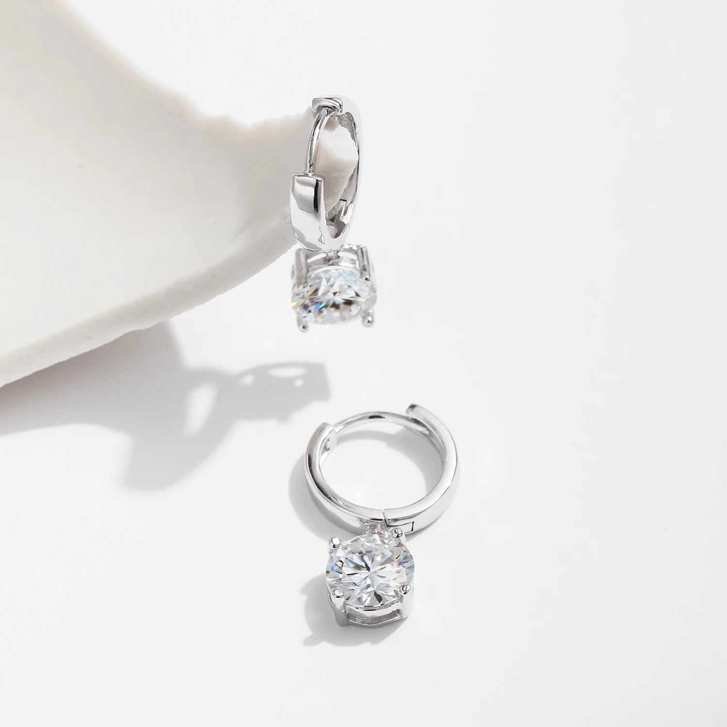 Elegant silver hoop earrings with a moissanite diamond center focus