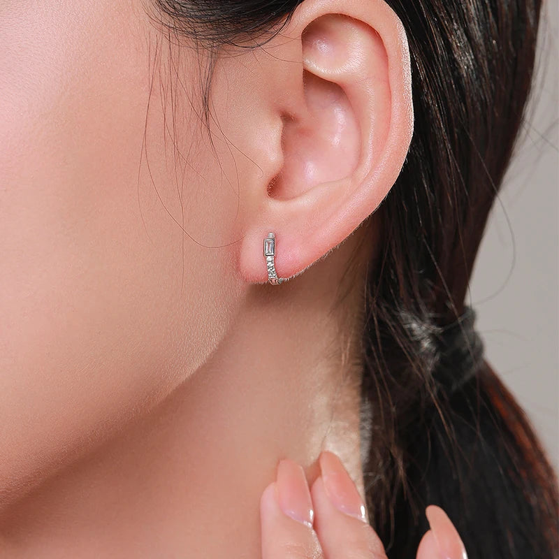 Sterling silver hoop earrings showing clear cz set along the hoop curve