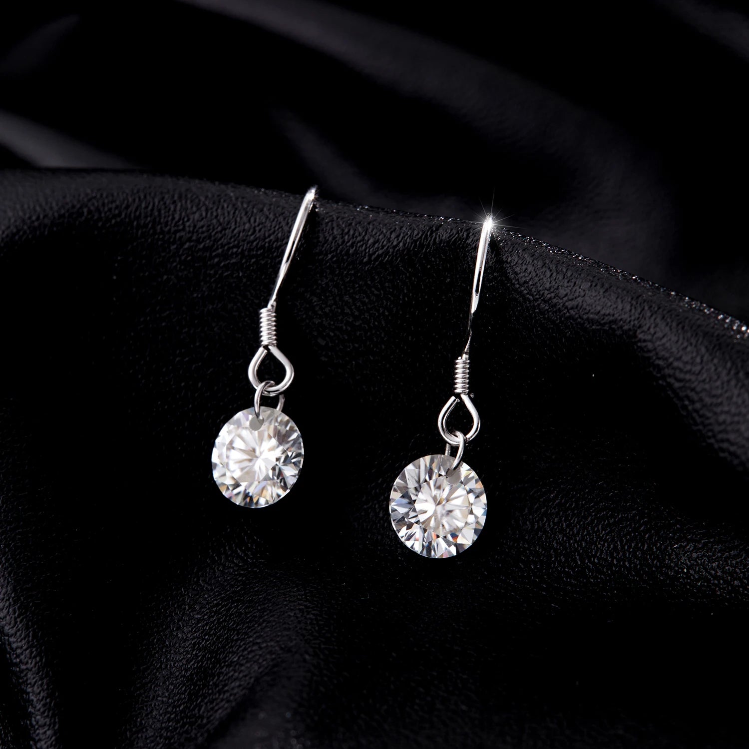 Soft light image highlighting earrings moissanite brilliance in silver