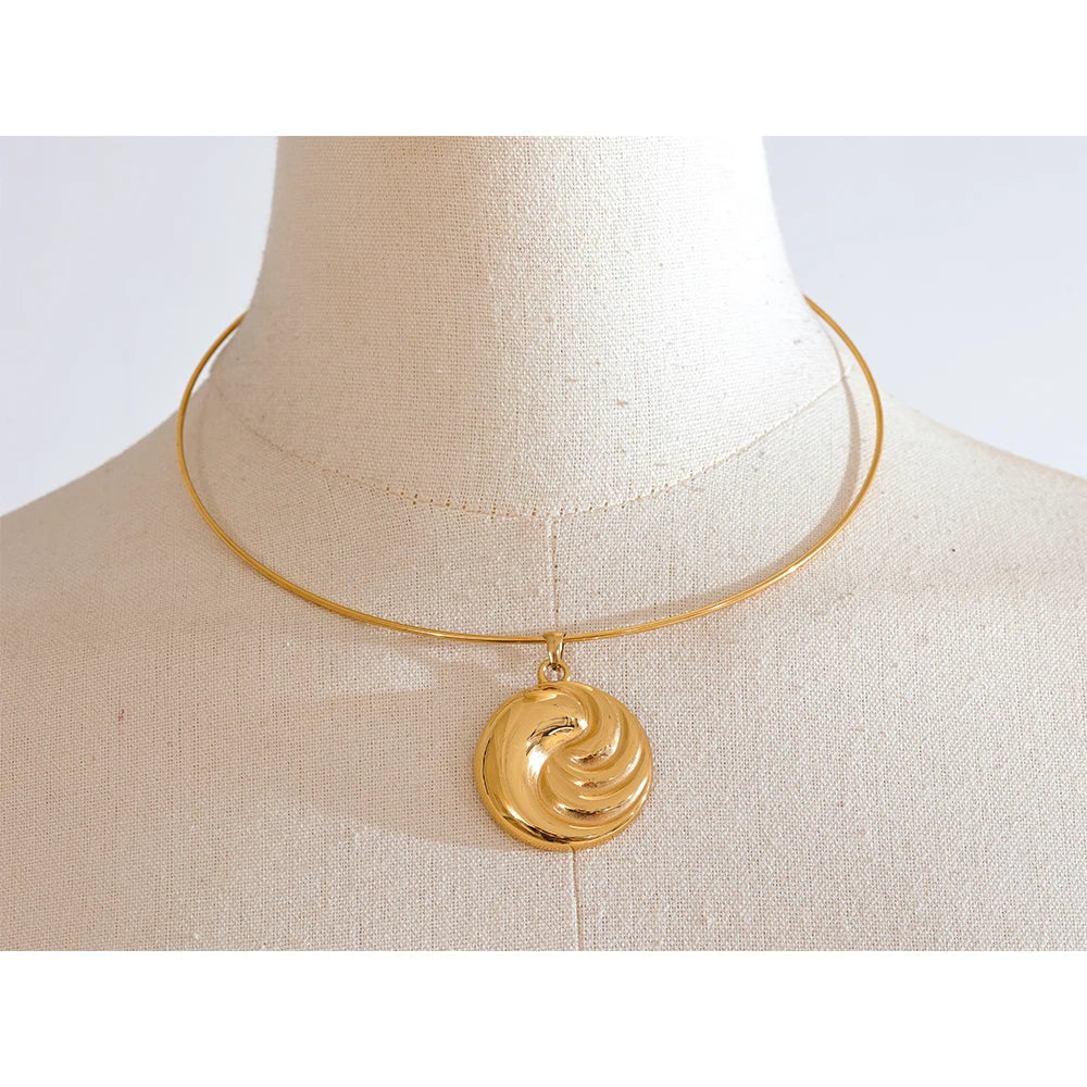 Close-up of gold necklace with polished collar design