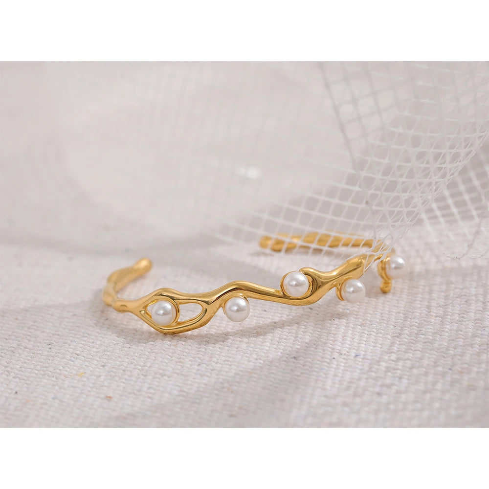 Gold cuff bracelet with pearls detail and steel frame