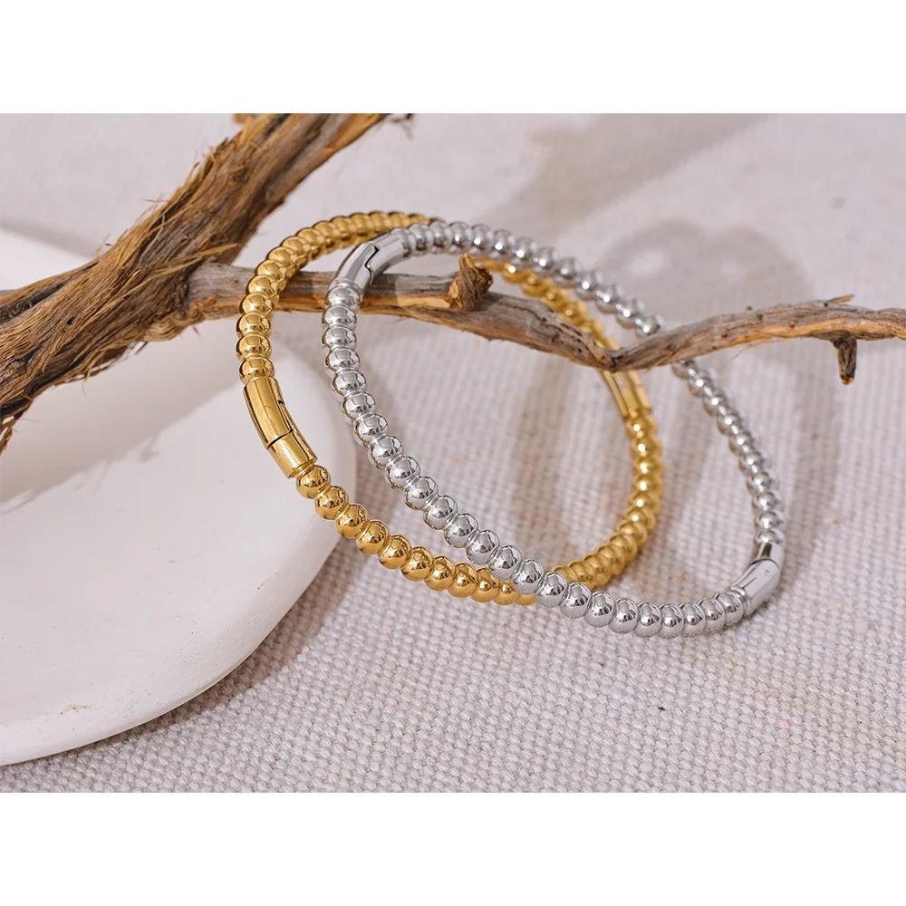 Minimal bangle and bangle stack featuring a bracelet charm accent