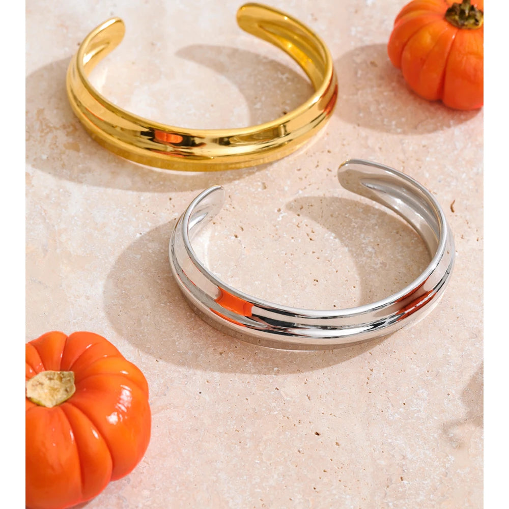 sleek gold bangle with minimal textured finish and open statement style