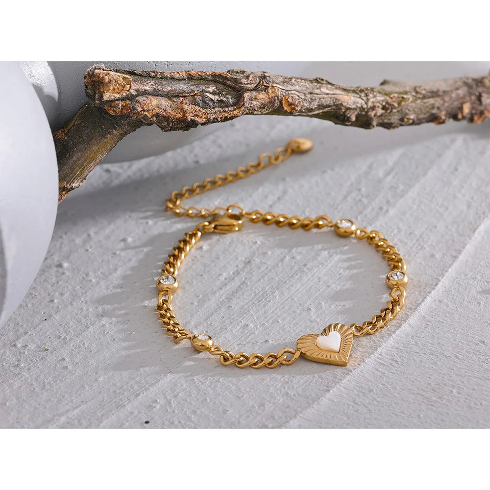 Gold chain bracelet showing a bright cubic zirconia centerpiece