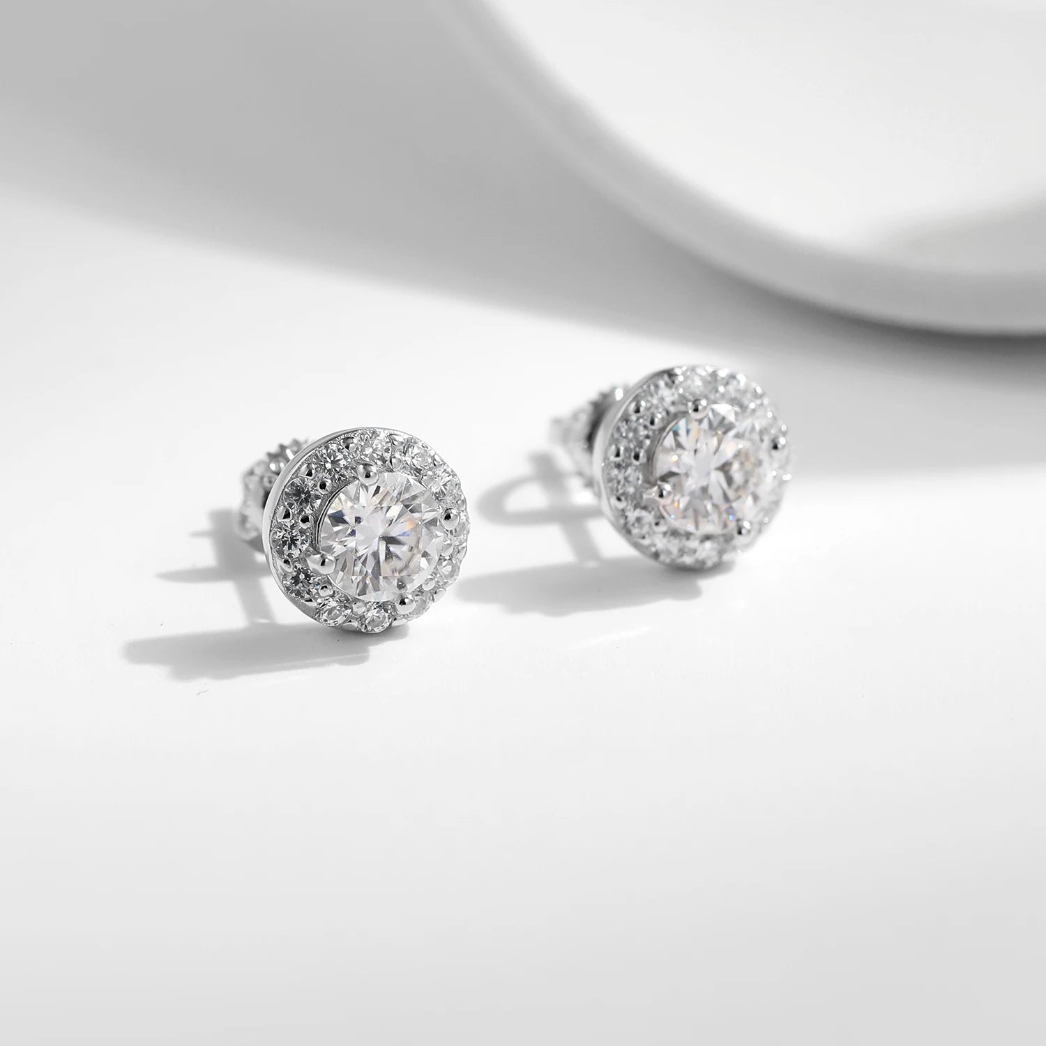 Moissanite earrings beside sterling silver earrings for a refined look