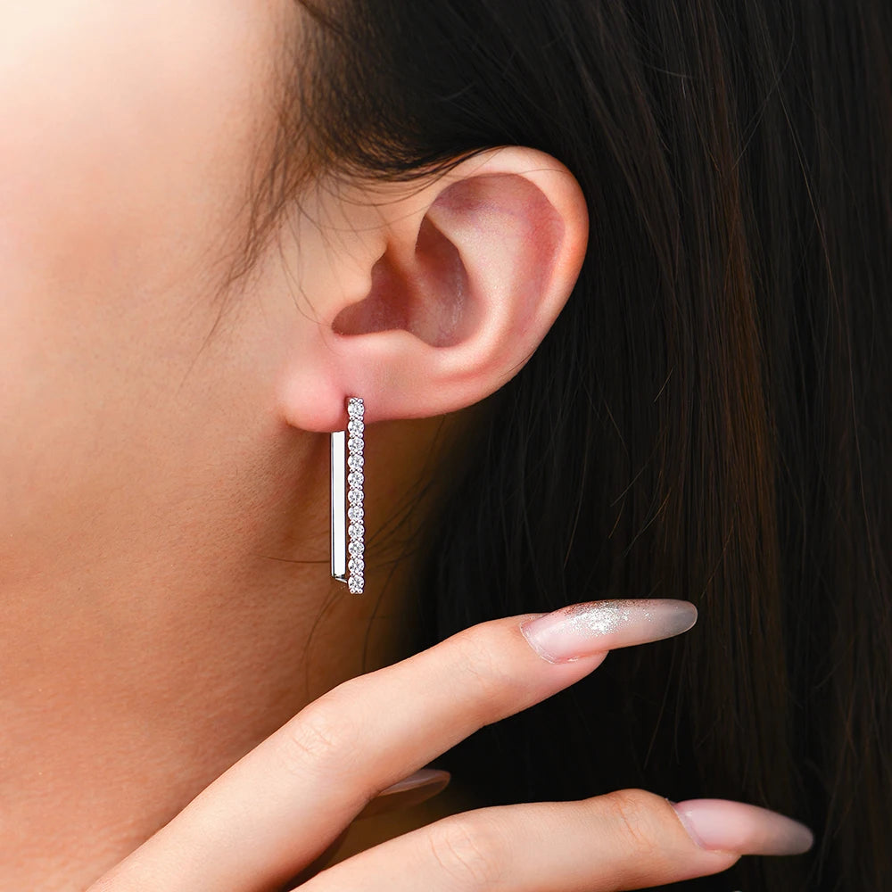 Moissanite earrings paired with a gold earrings for a two tone look