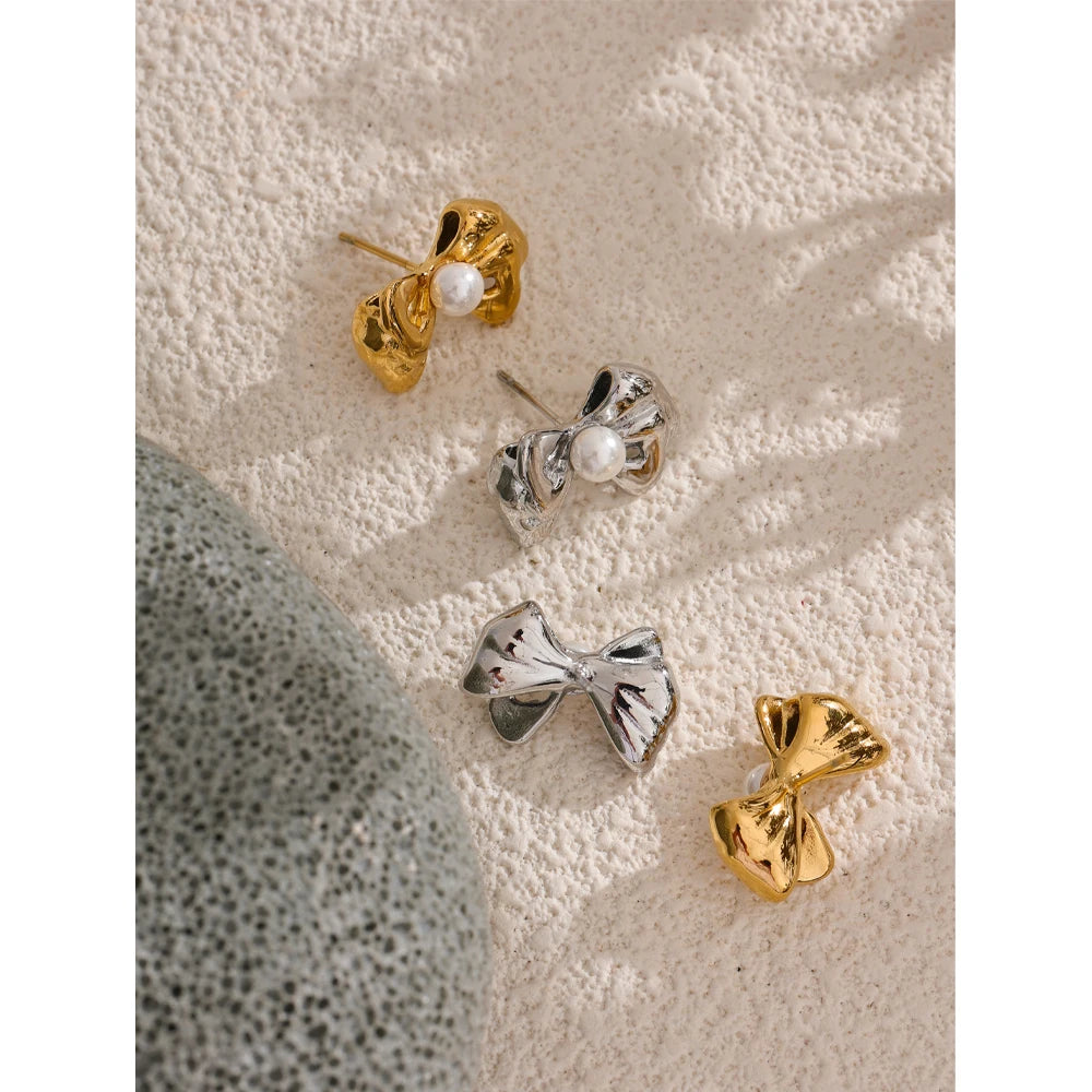 Close view of bow earrings showing pearl stud earrings detail