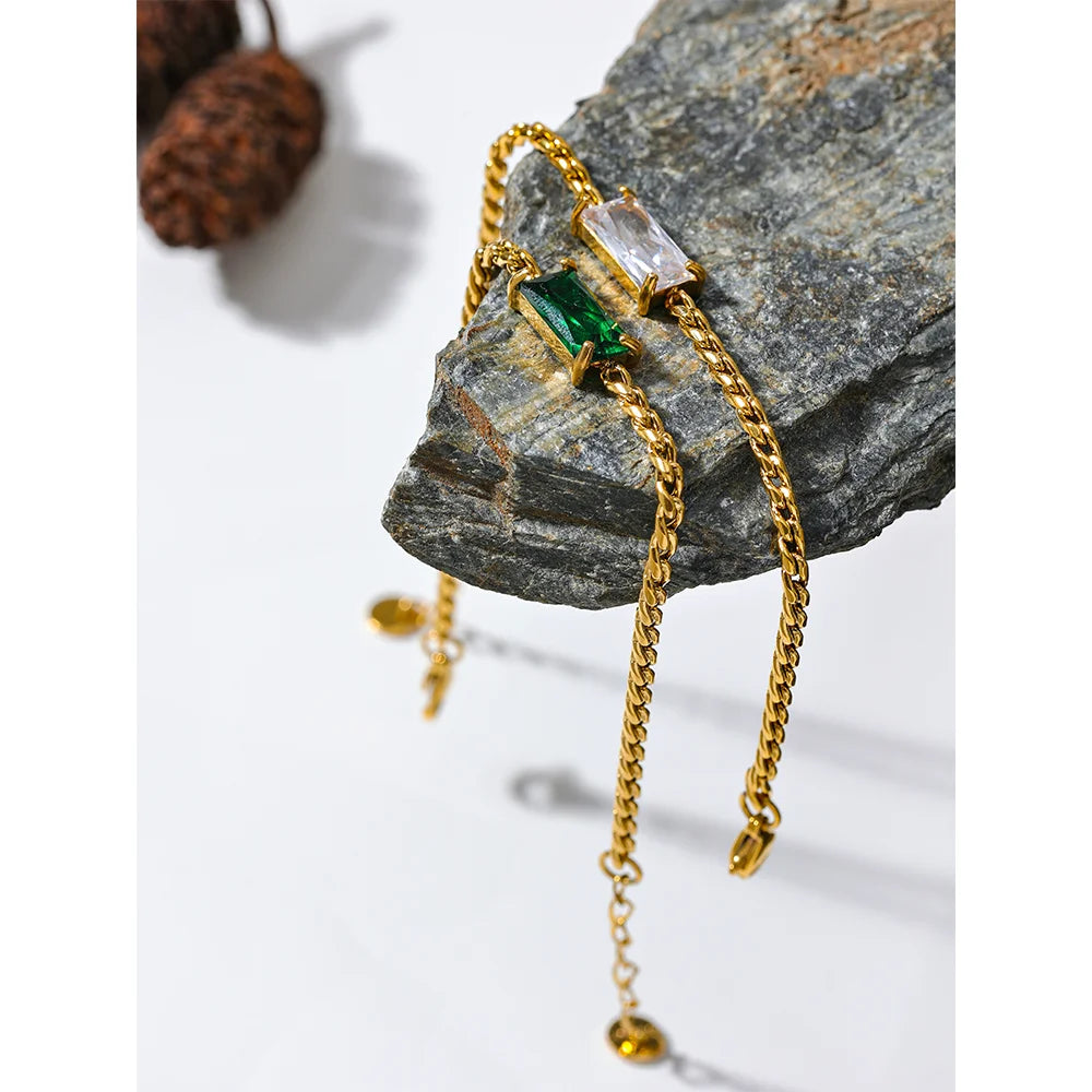 Minimal flatlay showing chain with gold beside cubic zirconia accents