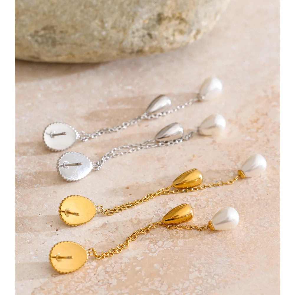 Close up of long chain pearl drop earrings gold plated