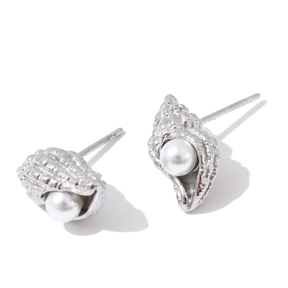 Gold earrings style featuring subtle conch shaped studs