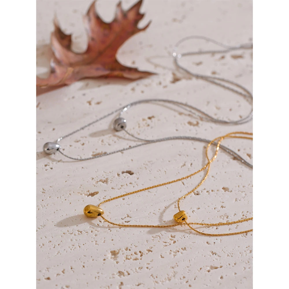 Minimal studio shot of gold plated pendant with necklace layers