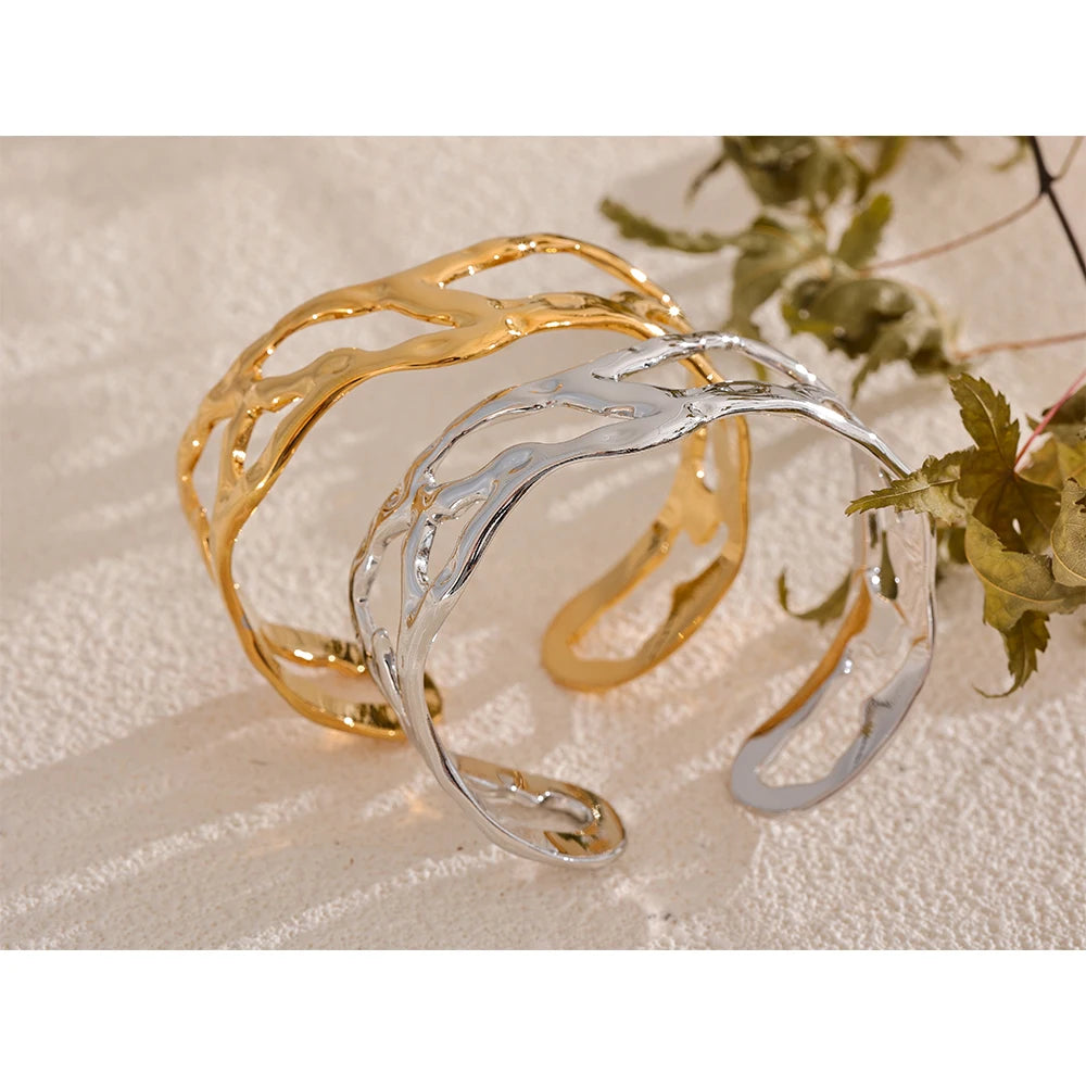 Wrist shot of bracelet with gold as a gold cuff with smooth bangle bracelet lines