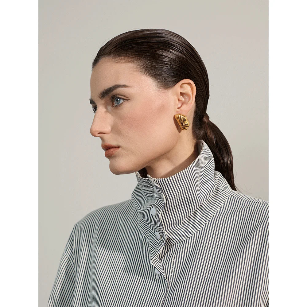 Close view of ear rings with earrings gold earrings shine in a modern profile