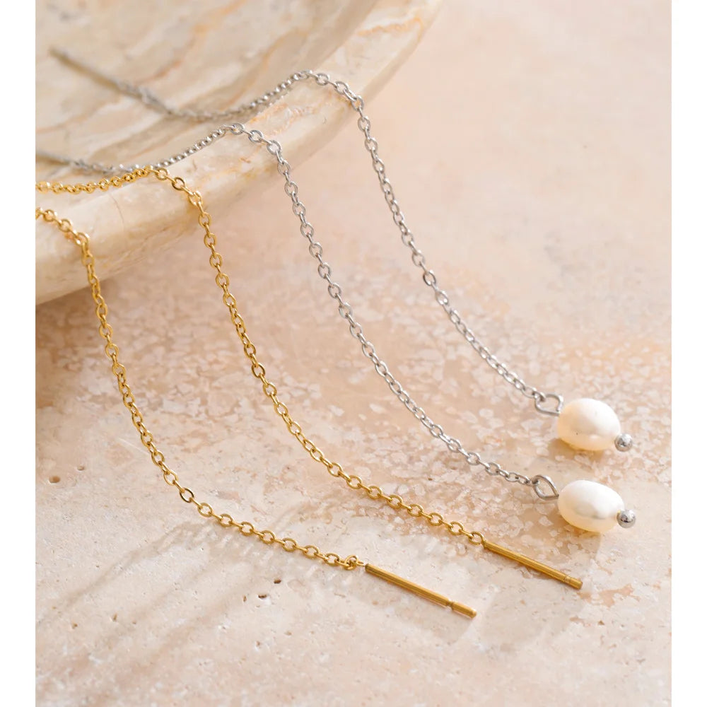 Close up of drop earrings gold with freshwater pearls