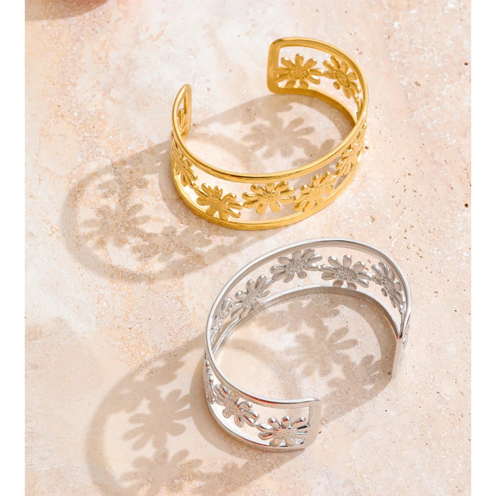 Close up of bracelet with gold finish and floral cutout